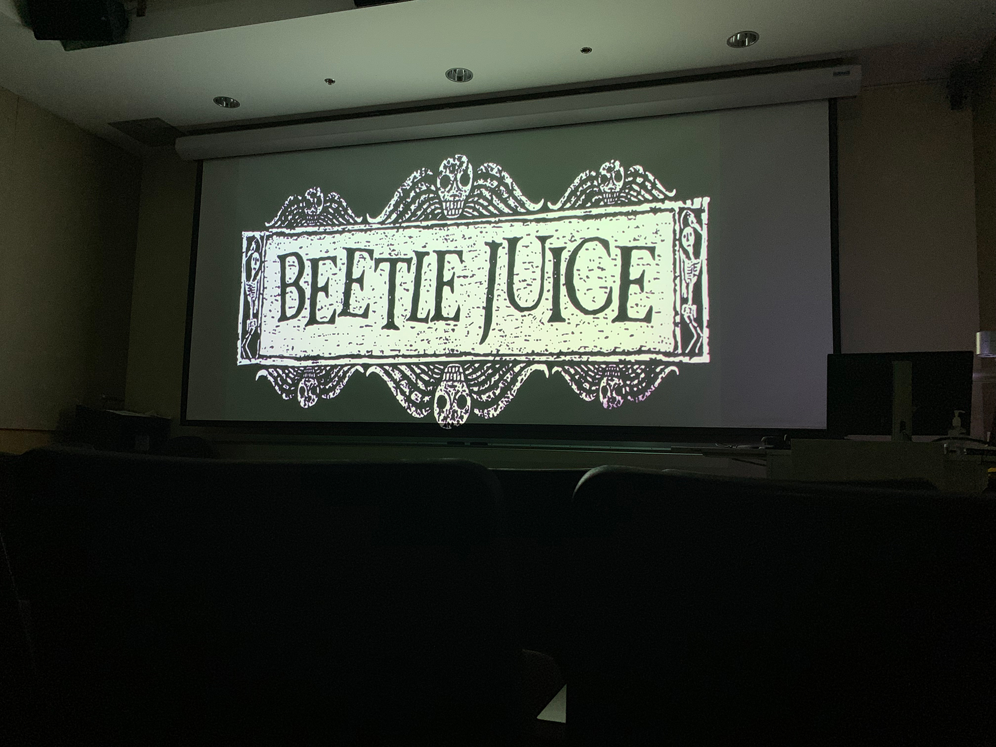 Image of the title card of “Beetlejuice” playing on a project in a Viking Union classroom.