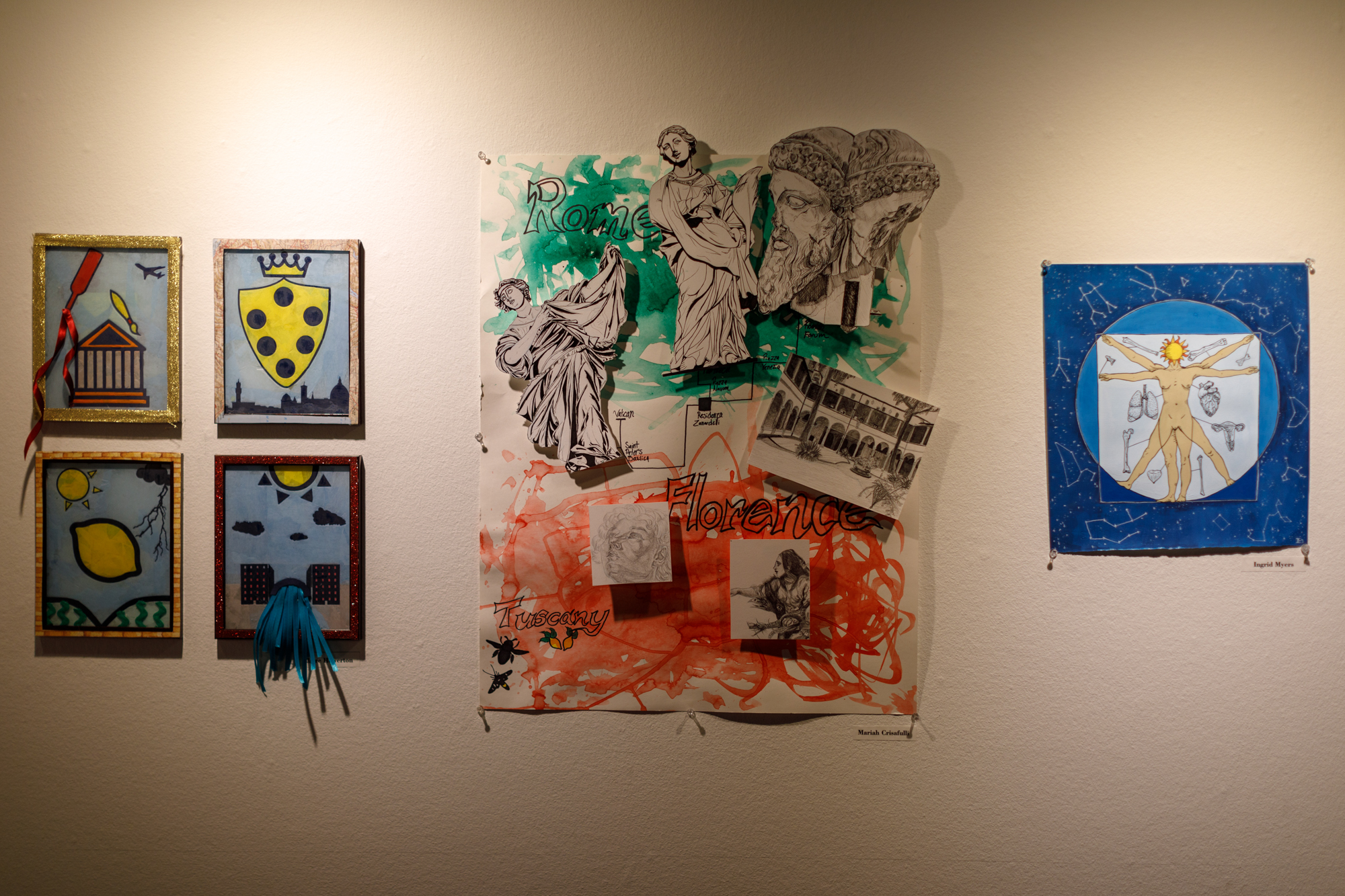 Image of three art pieces on the gallery wall.